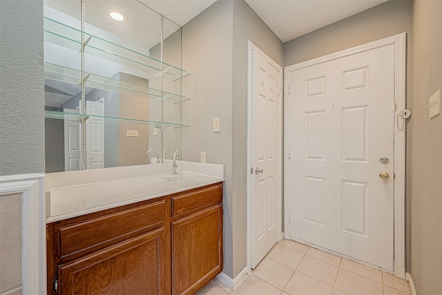 bathroom featuring tile patterned flooring and vanity