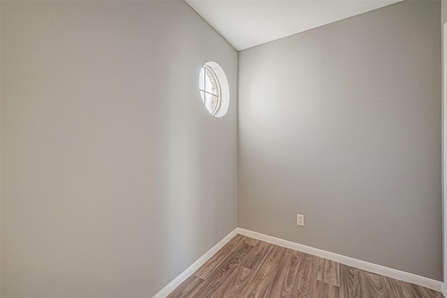 unfurnished room with light wood-type flooring and baseboards