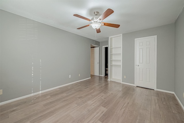 unfurnished bedroom featuring light wood-type flooring, ceiling fan, and baseboards