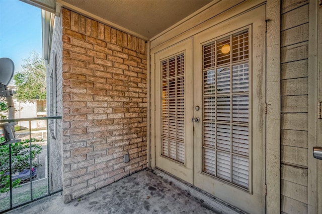 doorway to property with brick siding