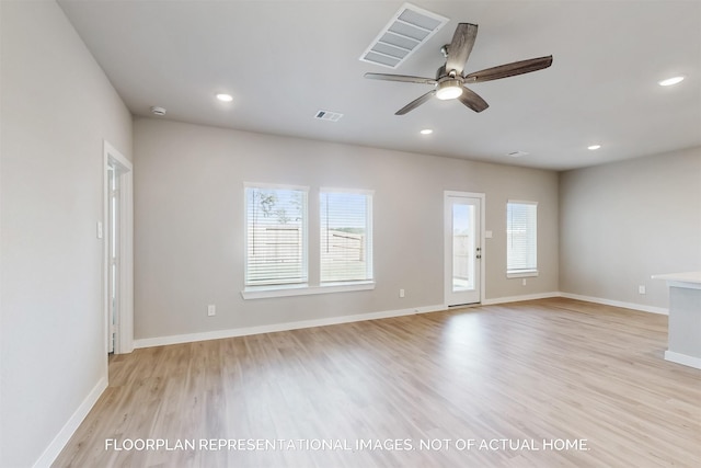 unfurnished room featuring recessed lighting, visible vents, light wood-style flooring, and baseboards