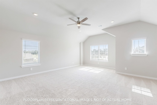 additional living space with vaulted ceiling, carpet, visible vents, and baseboards