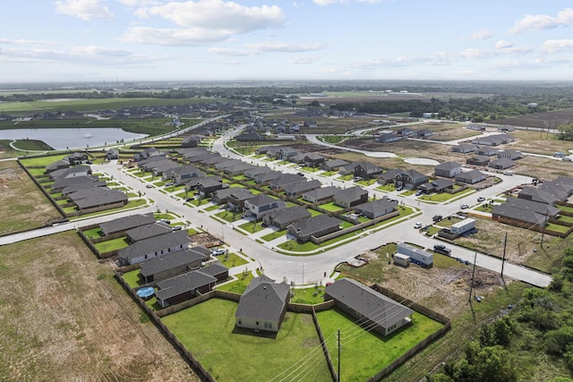 birds eye view of property featuring a water view and a residential view