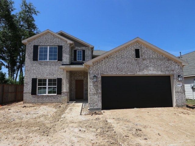 22427 Birchfield Grove Ln, New Caney, TX 77357 - view of front facade with brick siding, an attached garage, and driveway