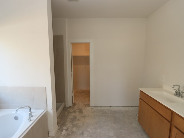 22427 Birchfield Grove Ln, New Caney, TX 77357 - full bathroom featuring vanity, a bath, and unfinished concrete flooring