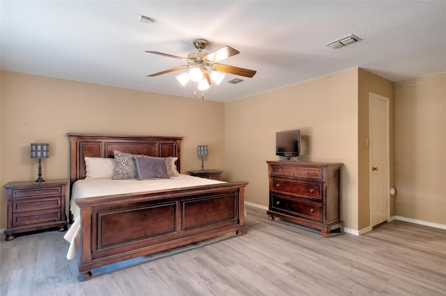 bedroom with light wood-type flooring, baseboards, and visible vents