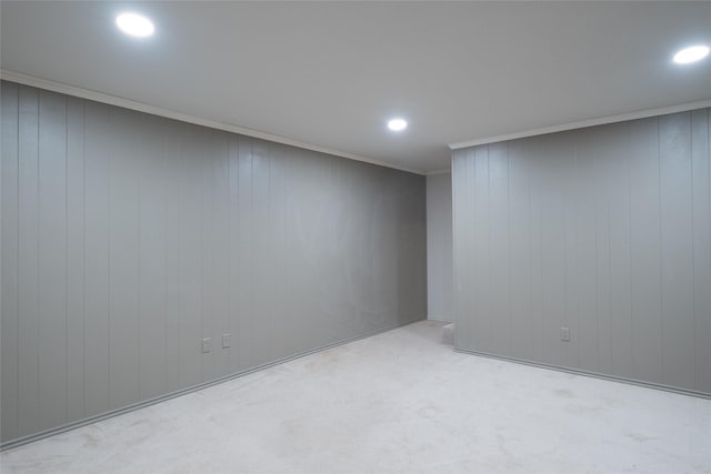 below grade area featuring recessed lighting, carpet flooring, and crown molding