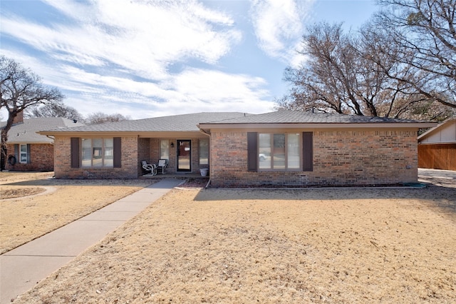 ranch-style house with brick siding and roof with shingles