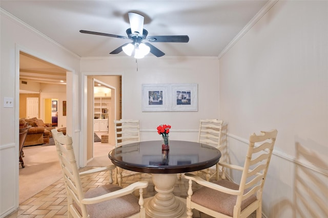 dining room featuring brick floor, ceiling fan, and ornamental molding