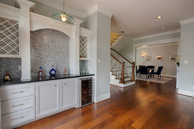 bar featuring wine cooler, dark wood-style flooring, a dry bar, decorative backsplash, and stairs