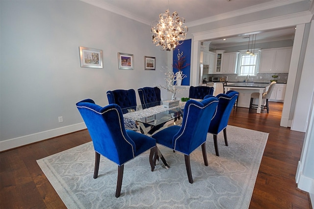 dining space with ornamental molding, dark wood-style flooring, baseboards, and an inviting chandelier