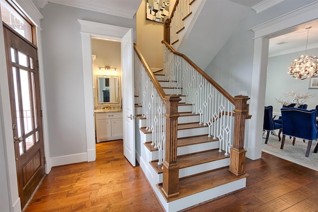 foyer with stairs, hardwood / wood-style floors, and crown molding