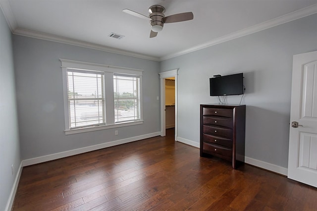 unfurnished bedroom with crown molding, dark wood finished floors, visible vents, ceiling fan, and baseboards