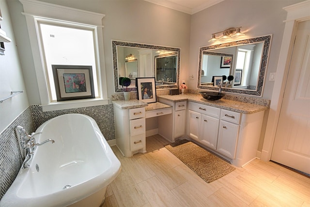 bathroom featuring a soaking tub, crown molding, vanity, and wood finished floors