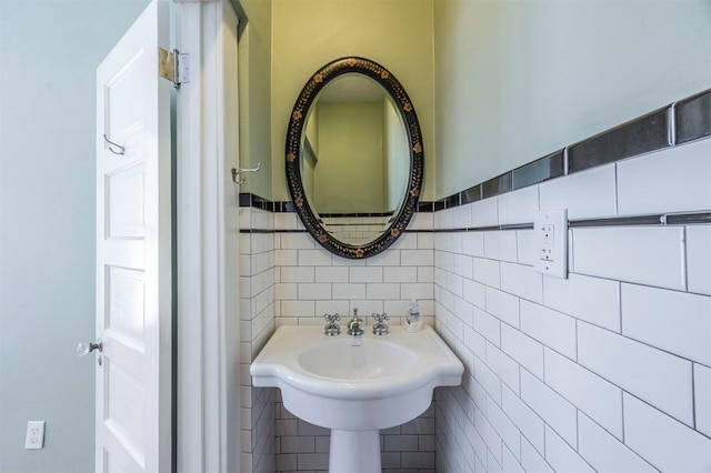 bathroom with tile walls