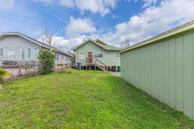 view of yard with cooling unit and fence