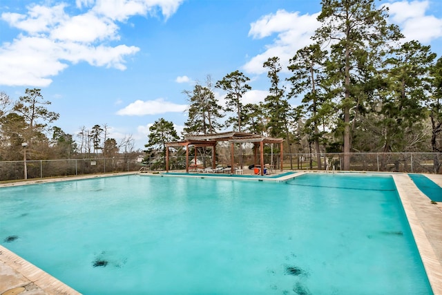 community pool with fence and a gazebo