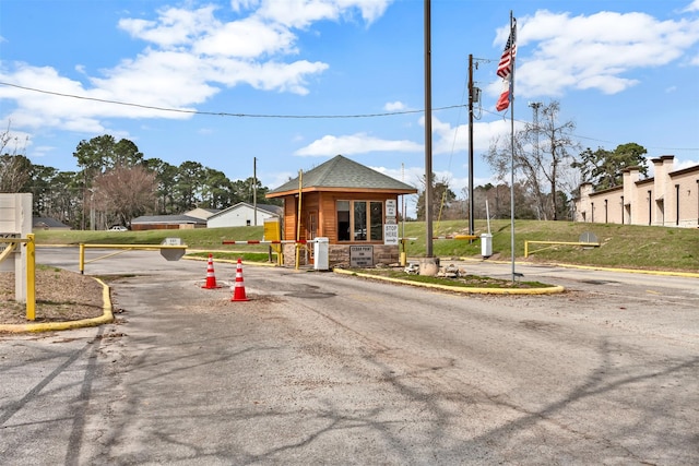 view of road featuring curbs and a gated entry