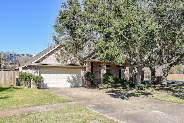 obstructed view of property featuring driveway, brick siding, fence, and a front yard