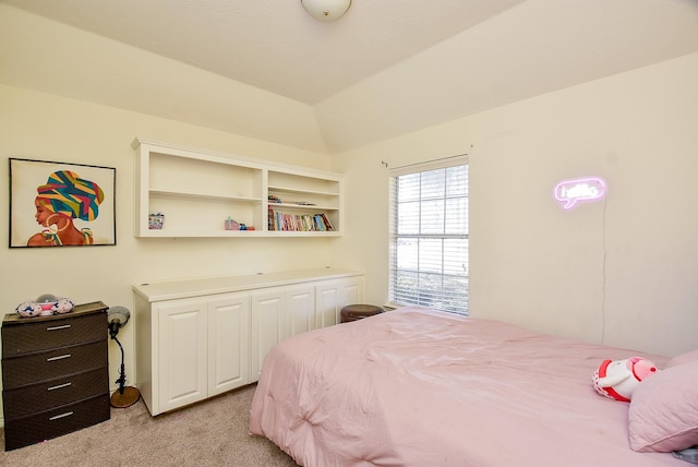 bedroom featuring light colored carpet and vaulted ceiling