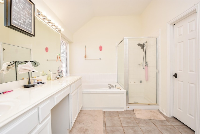 full bath featuring a stall shower, a garden tub, tile patterned flooring, vaulted ceiling, and a sink