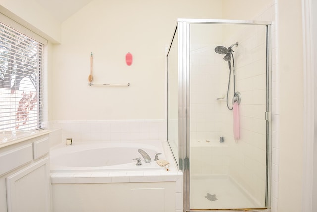 bathroom with a garden tub and a shower stall