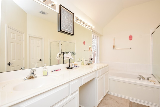 bathroom featuring lofted ceiling, double vanity, visible vents, and a sink