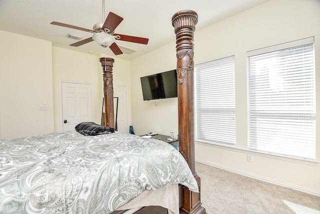 carpeted bedroom with baseboards, visible vents, and a ceiling fan