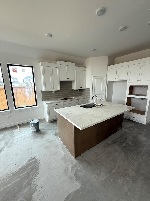11435 Desert Orangetip Way, Cypress, TX 77433 - kitchen featuring a sink, a center island with sink, white cabinetry, and tasteful backsplash