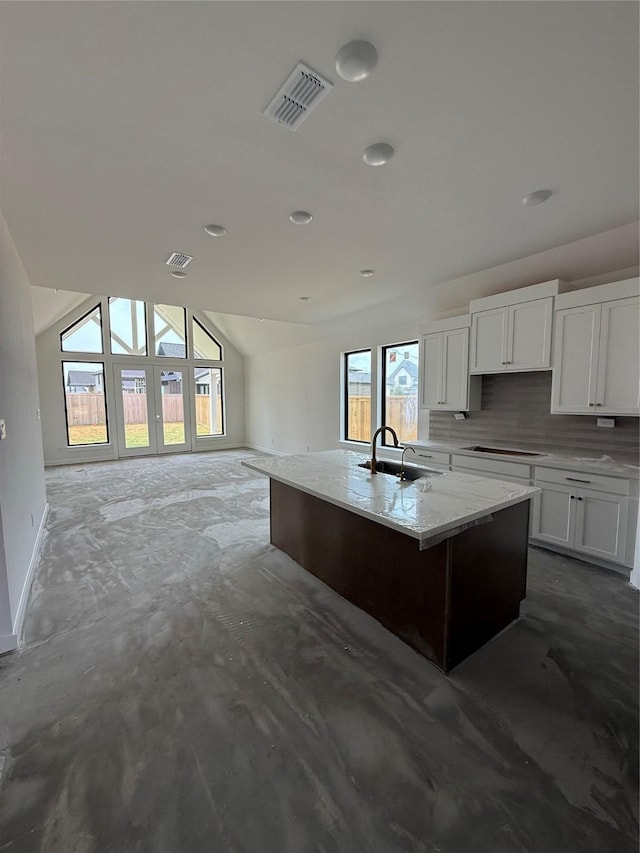 11435 Desert Orangetip Way, Cypress, TX 77433 - kitchen featuring a sink, white cabinetry, open floor plan, decorative backsplash, and vaulted ceiling