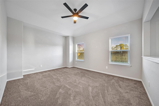 empty room featuring carpet floors, baseboards, and a ceiling fan