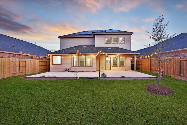 rear view of house featuring a lawn, a patio area, and a fenced backyard