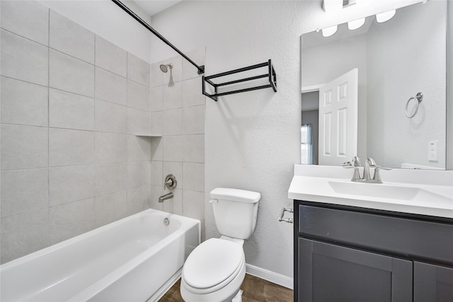 full bathroom with a textured wall, toilet, washtub / shower combination, vanity, and wood finished floors