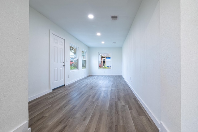 unfurnished room with dark wood-type flooring, recessed lighting, visible vents, and baseboards