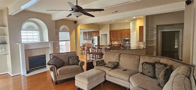 811 Piney Ridge Dr, Friendswood, TX 77546 - living area featuring a ceiling fan, light wood-type flooring, beamed ceiling, recessed lighting, and a tiled fireplace