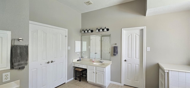 811 Piney Ridge Dr, Friendswood, TX 77546 - bathroom featuring vanity, tile patterned floors, and vaulted ceiling