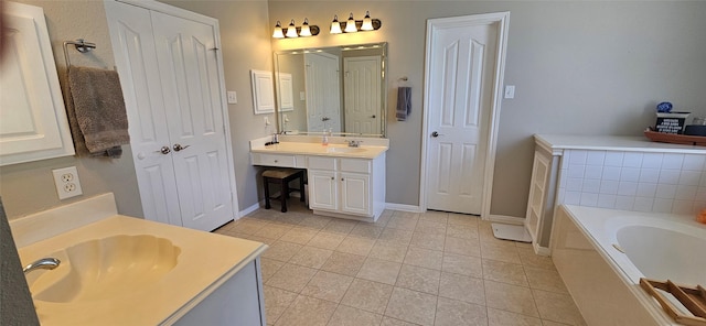 811 Piney Ridge Dr, Friendswood, TX 77546 - full bathroom featuring two vanities, a bath, tile patterned floors, and a closet
