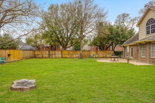 view of yard with a patio area and a fenced backyard