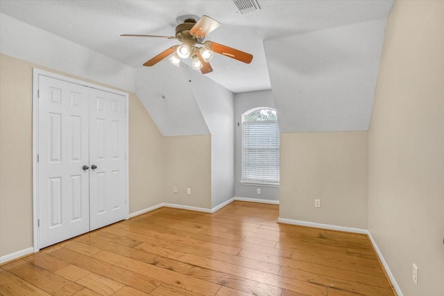 bonus room featuring lofted ceiling, light wood-style floors, ceiling fan, and baseboards