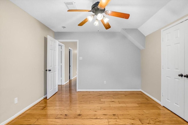 interior space featuring light wood-style floors, visible vents, baseboards, and a ceiling fan