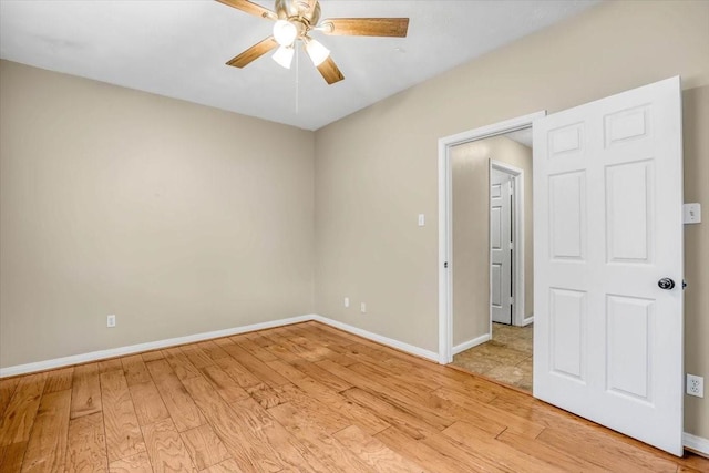 unfurnished room with ceiling fan, light wood-type flooring, and baseboards