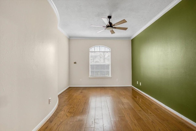 unfurnished room with a textured ceiling, ceiling fan, wood-type flooring, and crown molding