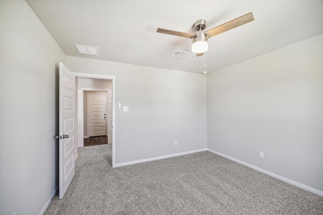 empty room featuring visible vents, a ceiling fan, baseboards, and carpet floors