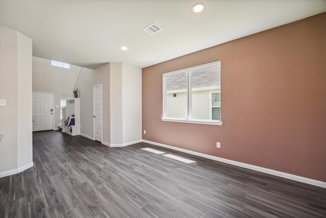 unfurnished living room featuring recessed lighting, visible vents, baseboards, and dark wood finished floors