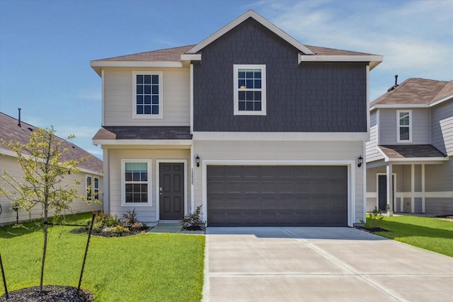 traditional home featuring a front yard, concrete driveway, and a garage