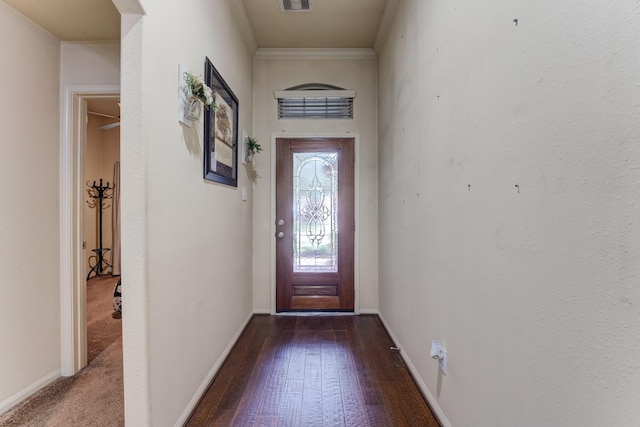 doorway to outside featuring visible vents, ornamental molding, hardwood / wood-style flooring, and baseboards