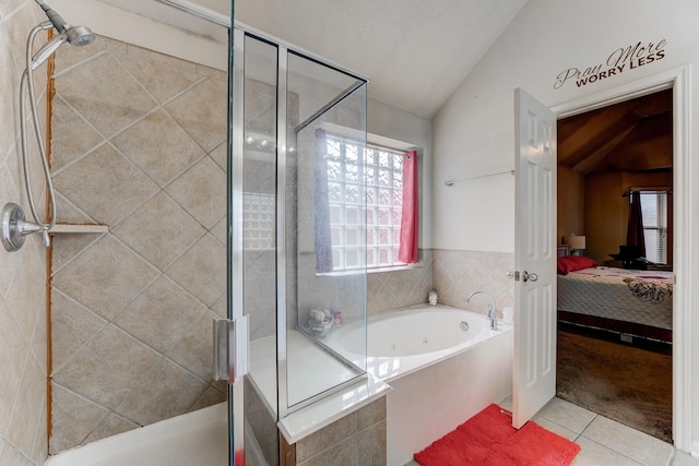 bathroom with lofted ceiling, a shower stall, ensuite bath, a jetted tub, and tile patterned floors