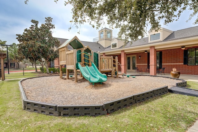 community jungle gym featuring french doors, fence, and a lawn