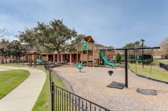 community play area featuring fence and a yard