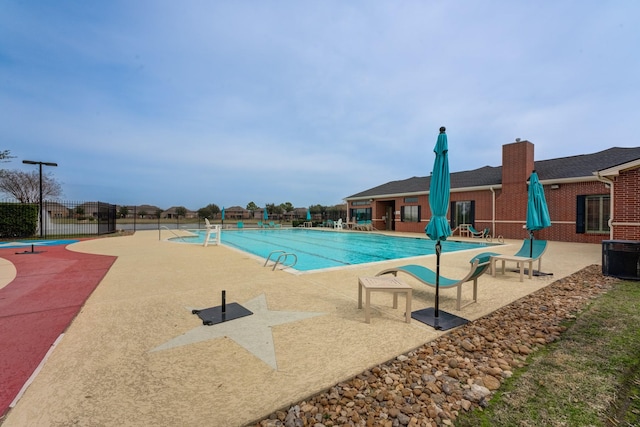 community pool featuring a patio area and fence